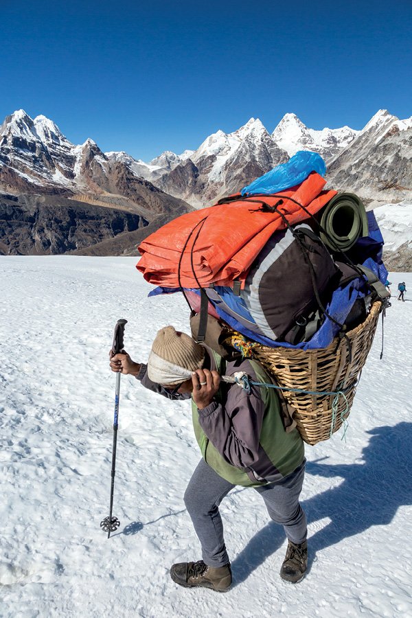 Guide sherpa progressant sur un glacier himalayen, figure centrale des nouvelles règles qui rendent le recours à un guide népalais certifié obligatoire sur tous les 8 000 mètres du Népal.