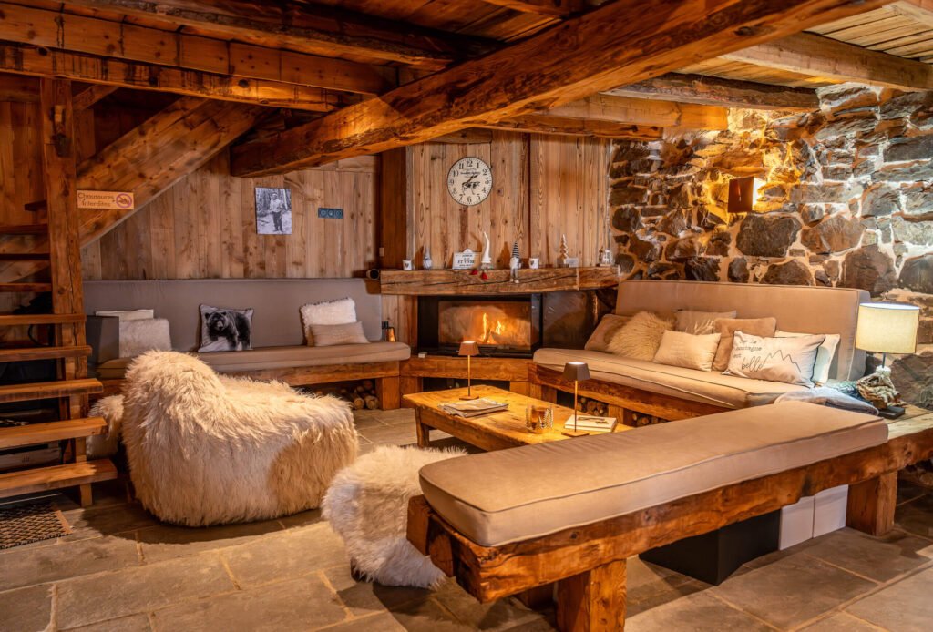 Intérieur rustique et chaleureux tout en bois d'un refuge de montagne, éclairé à la lueur des bougies et du feu de cheminée.
Image 3 : Le privilège du lever de soleil